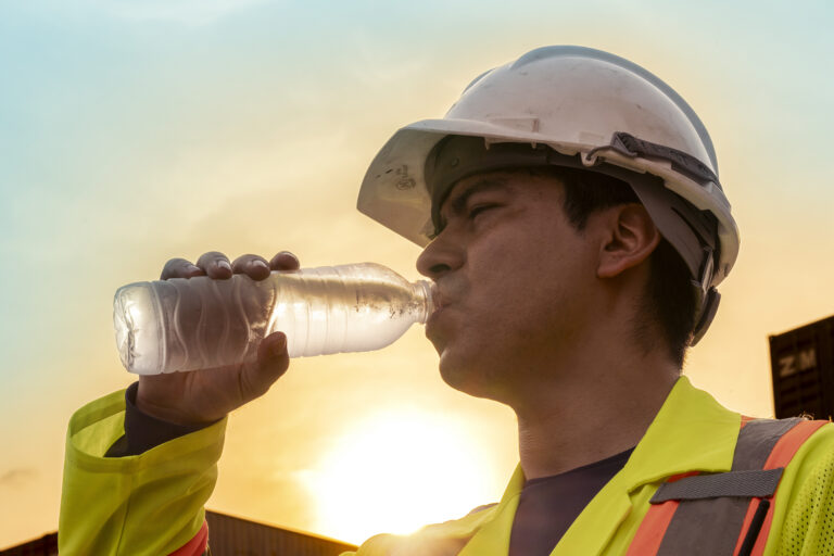 Construction worker staying hydrated in the texas heat